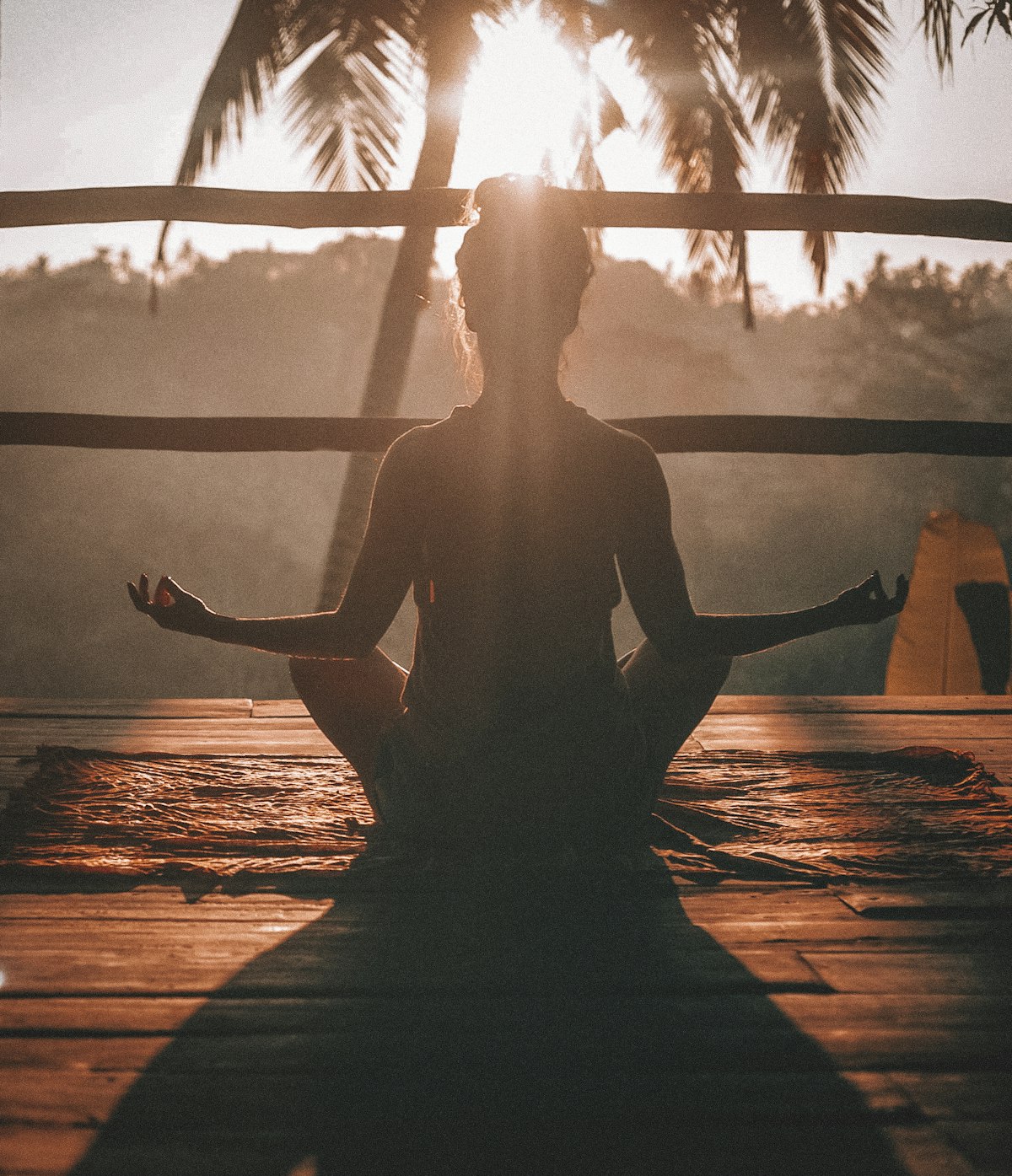 Woman meditating in warm morning sunlight